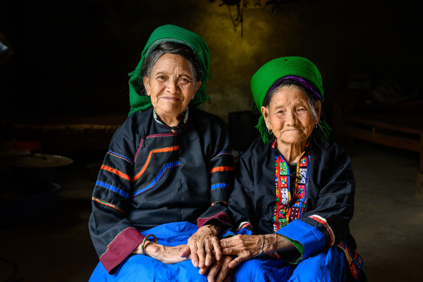 Smiling ethnic minority woman in northern Vietnam wearing traditional clothing, representing ethnic minority Vietnam culture.